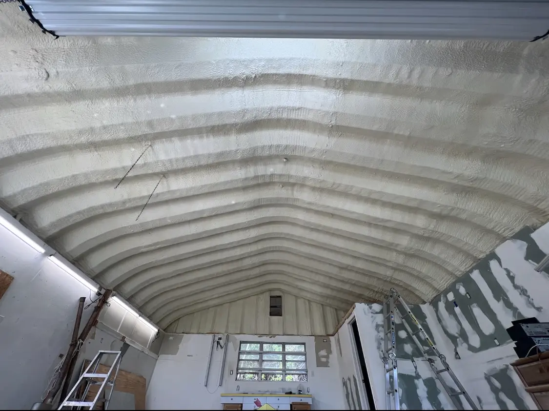 Spray polyurethane foam applied to the underside of a metal roof deck in Utica